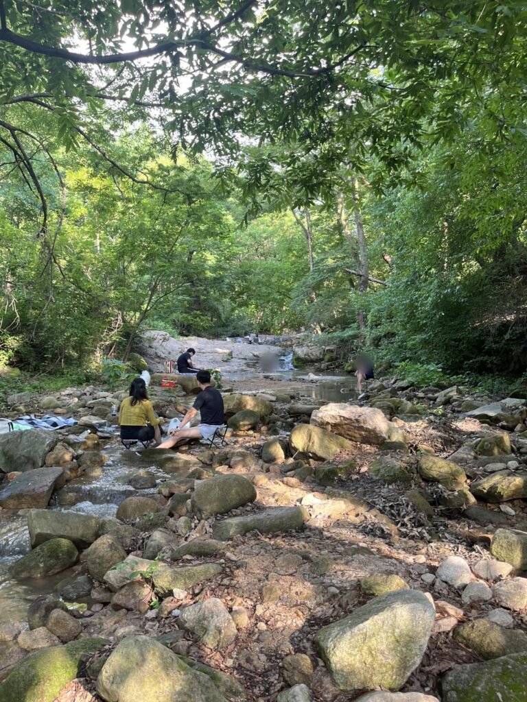 People relaxing on the rocks along the stream at Jingwansa Valley, Bukhansan, Seoul