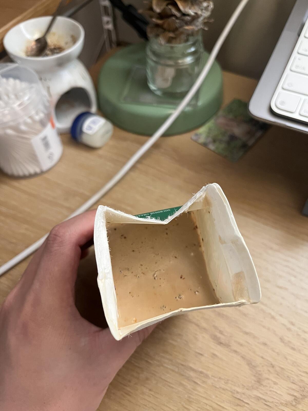 A view inside an opened milk carton of Korean coffee mix dissolved into the milk.