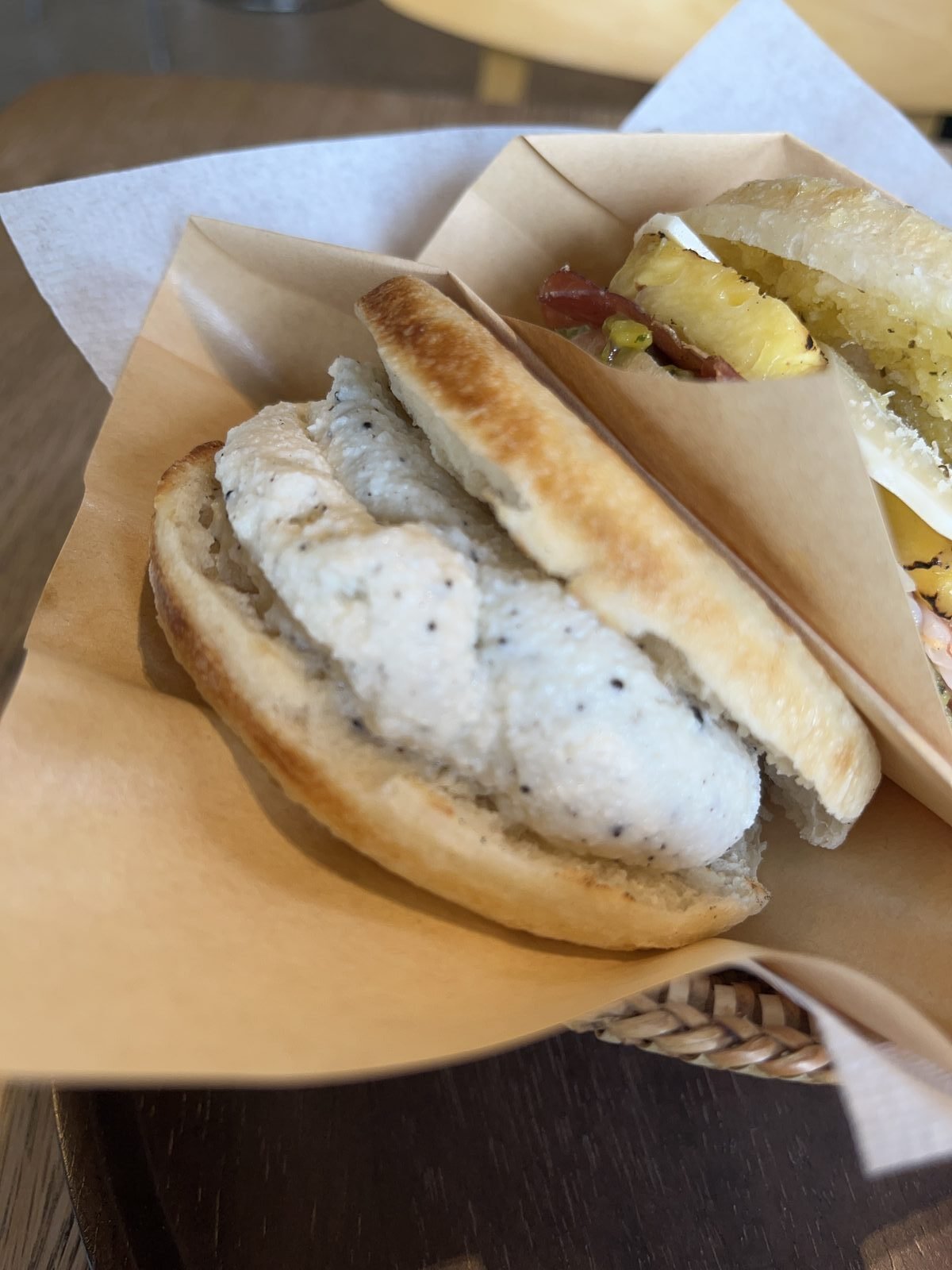Truffle ricotta tigella split open, the white spread against browned bread
