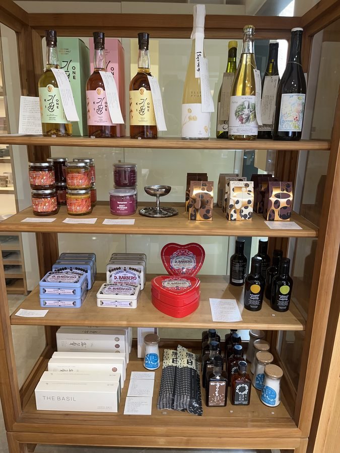 Wooden shelves of bottles, jars and packaged goods on the third floor.