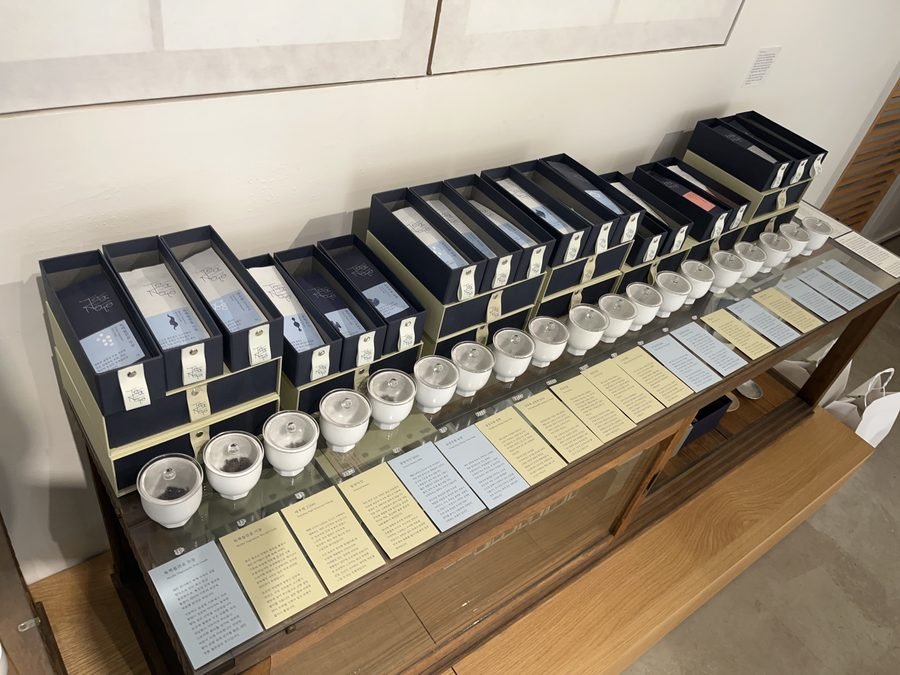 A long counter lined with boxed sets and white cups.