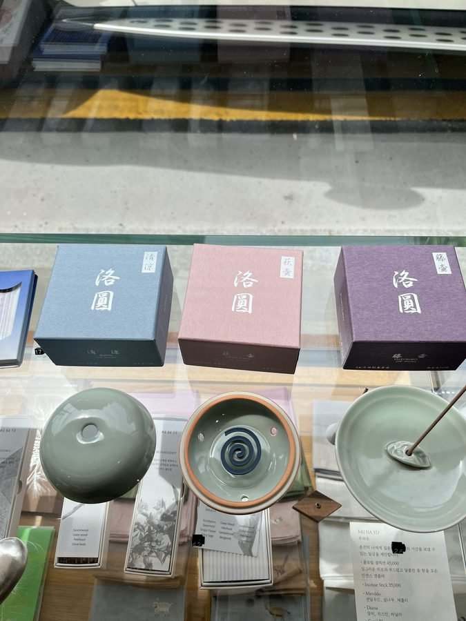 Incense holders and boxed incense in a display case.